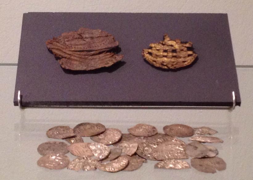Pouch of leather with gold print and silver coins. C. 1010 AD.
