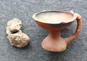 Incense and a bowl used during worship of the house god.