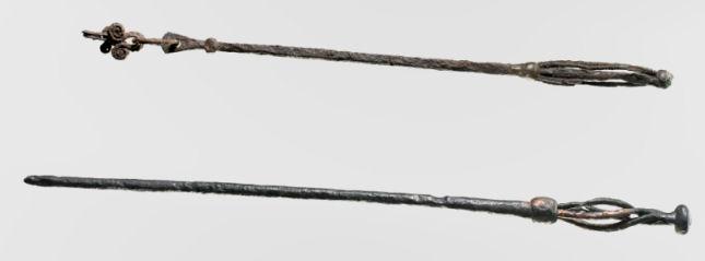 Two volva staves from archaeological sites, both simple handles with bulbed tops